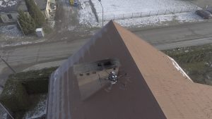Dron pobiera próbkę dumu, by określić stężenie pyły wydobywającego się z komina.